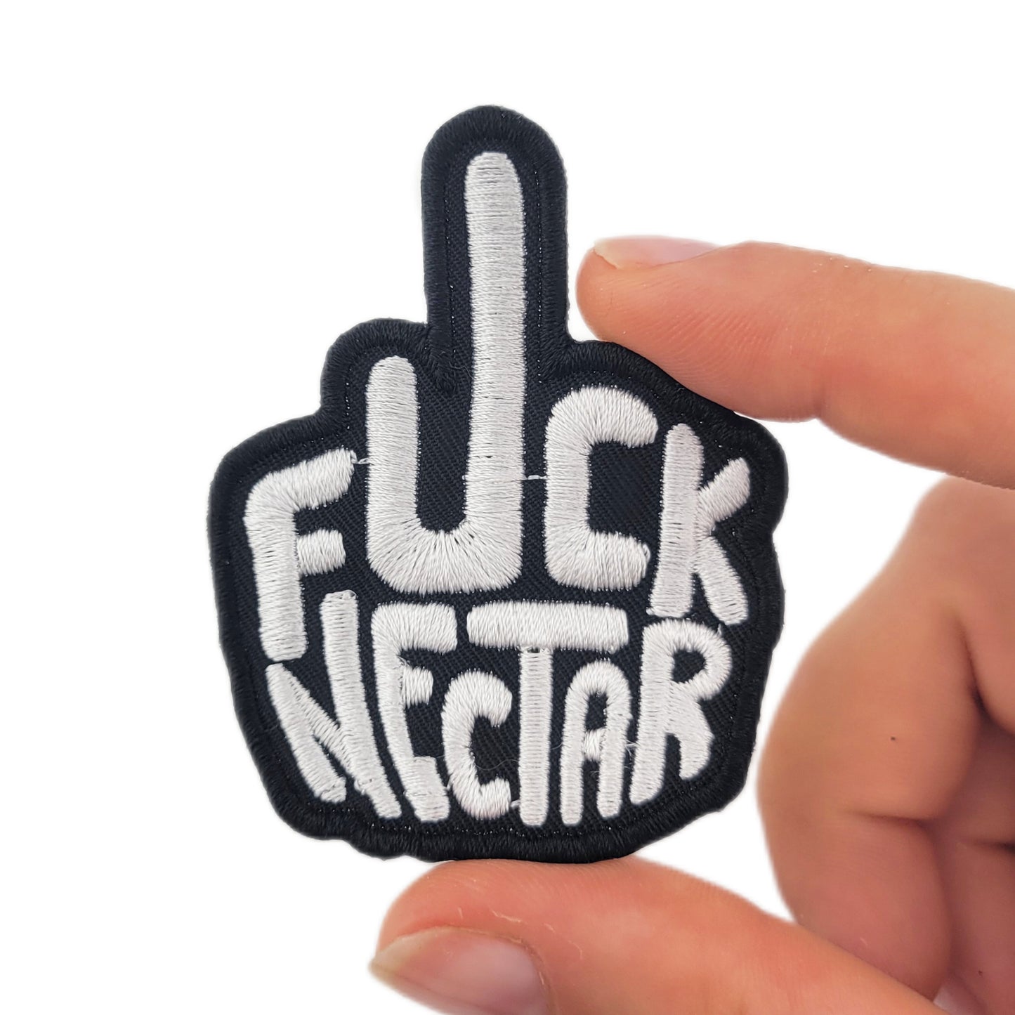 Patch with 'F*ck Nectar' text held by a hand on a white background