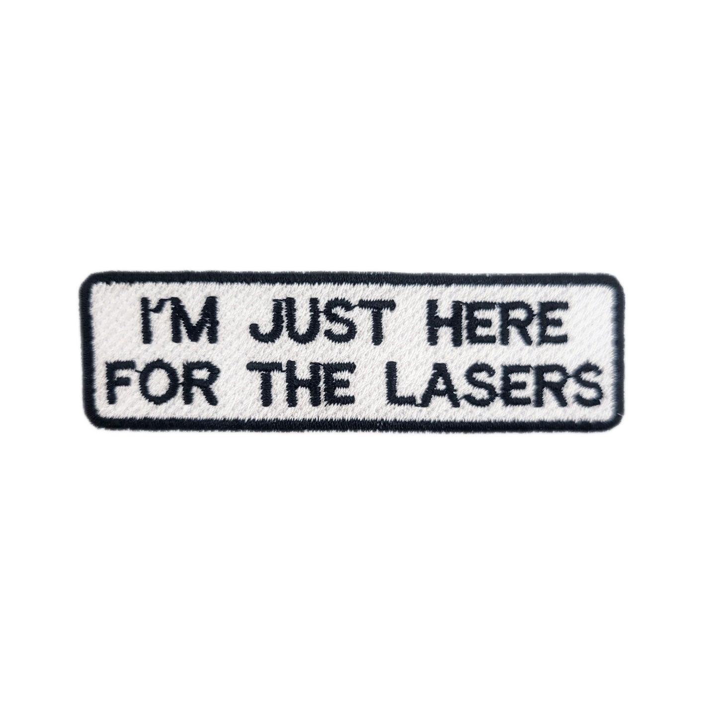 Embroidered patch with text 'I'M JUST HERE FOR THE LASERS' written in black text on a white background