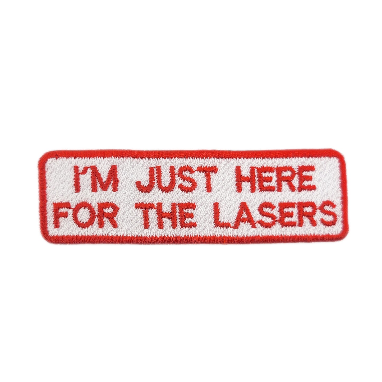 Embroidered patch with text 'I'm just here for the lasers' written in red on a white background