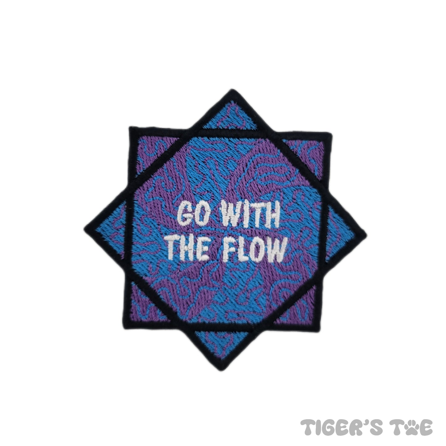 Embroidered patch of a blue and purple flow star with decorative swirls. The center of the flow star reads "GO WITH THE FLOW" in white text.