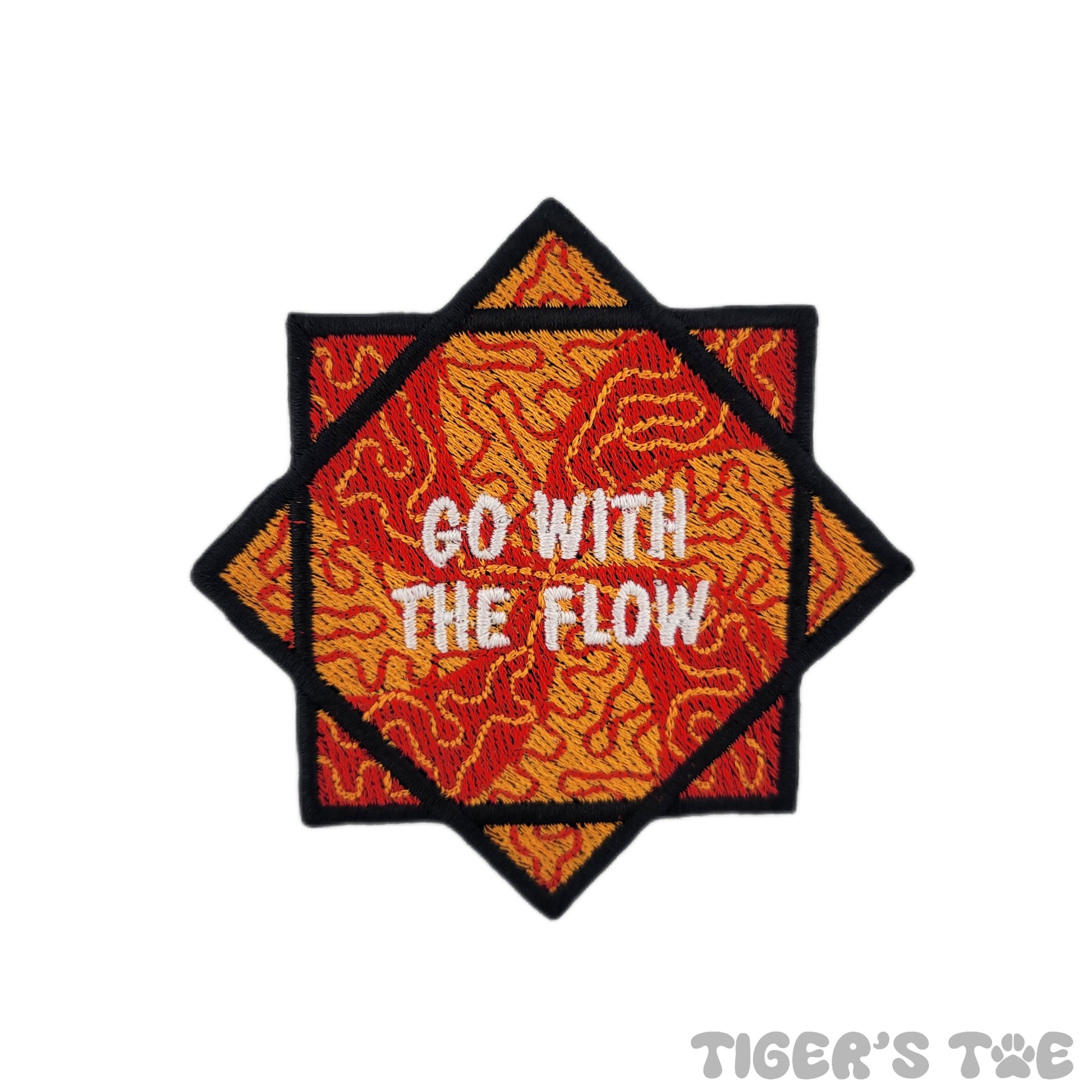 Embroidered patch of a red and orange flow star with decorative swirls. The center of the flow star reads "GO WITH THE FLOW" in white text.