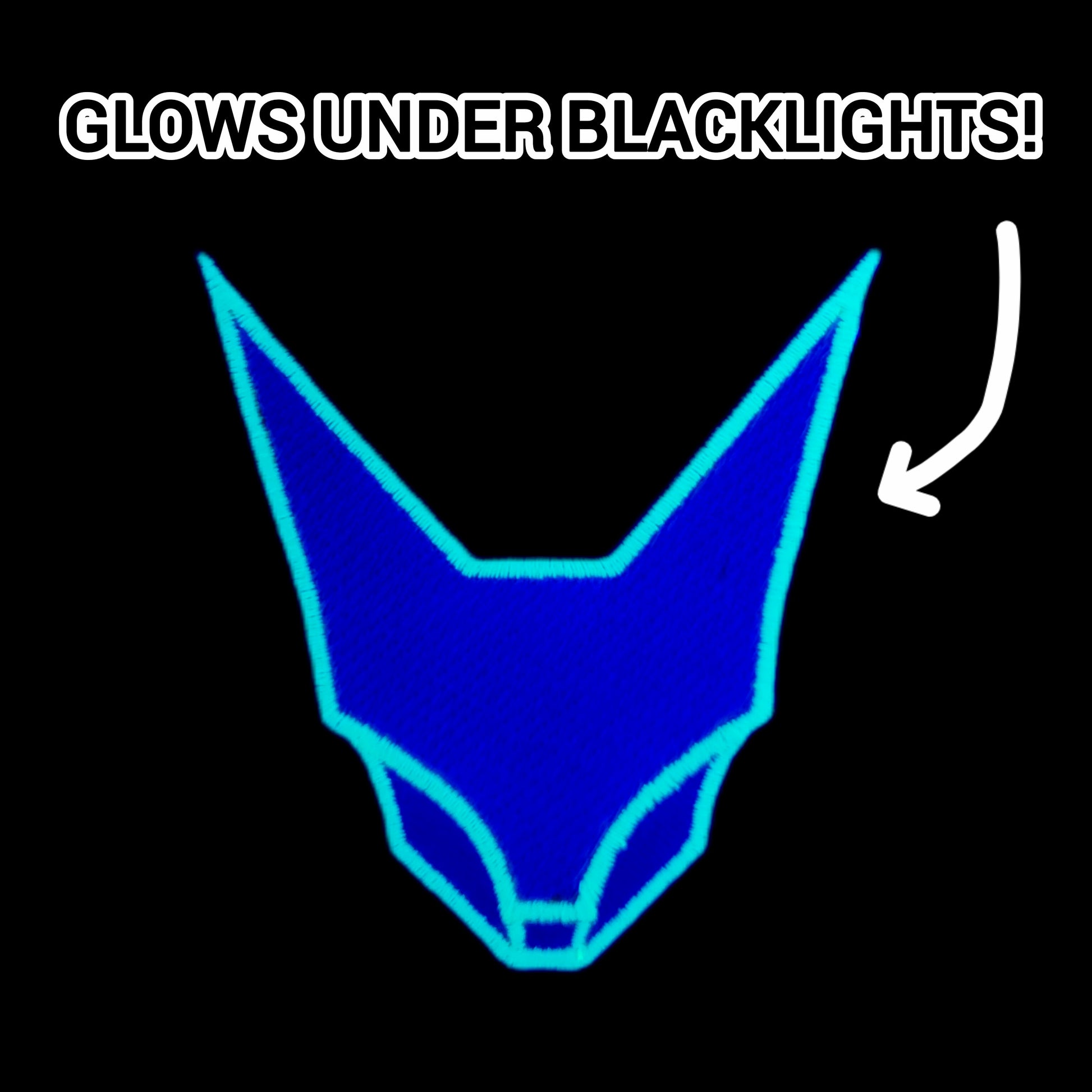 Green geometric abstraction feline face patch, shown under blacklight. 