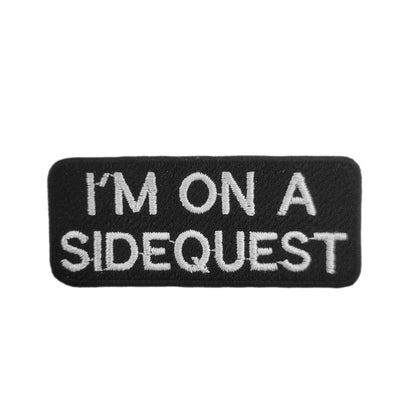 Black patch with white text 'I'm on a sidequest' on a white background