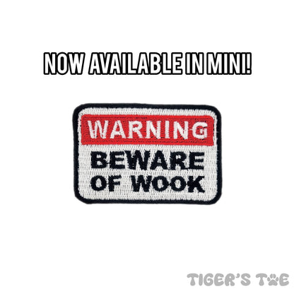 embroidered patch in the design of a warning sign that reads 'warning beware of wook'