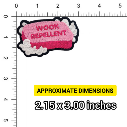 Pink soap patch with 'WOOK REPELLENT' text on a ruler for size reference
