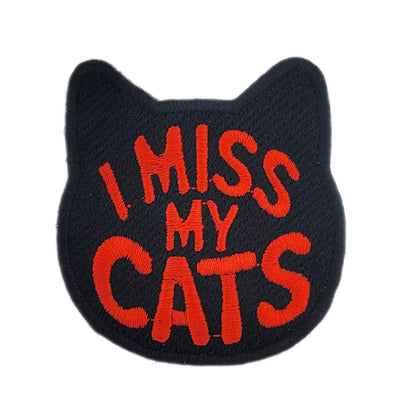 Black patch with red text 'I MISS MY CATS' on a white background