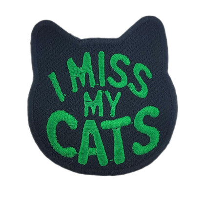 Black cat-shaped patch with 'I MISS MY CATS' text in green on a white background