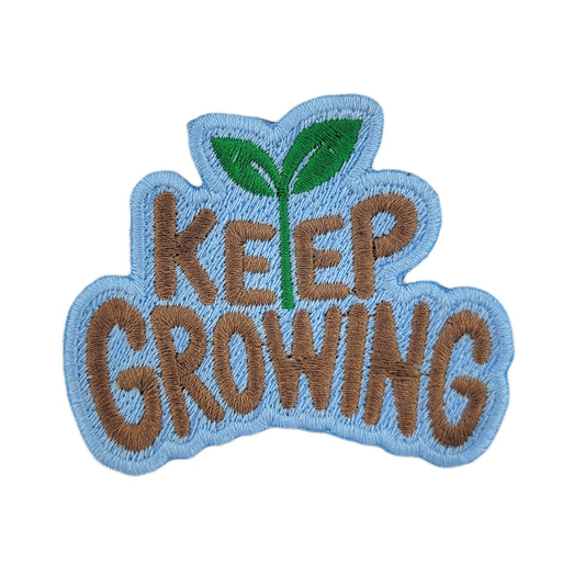 Embroidered patch with 'KEEP GROWING' text and a green leaf on a white background