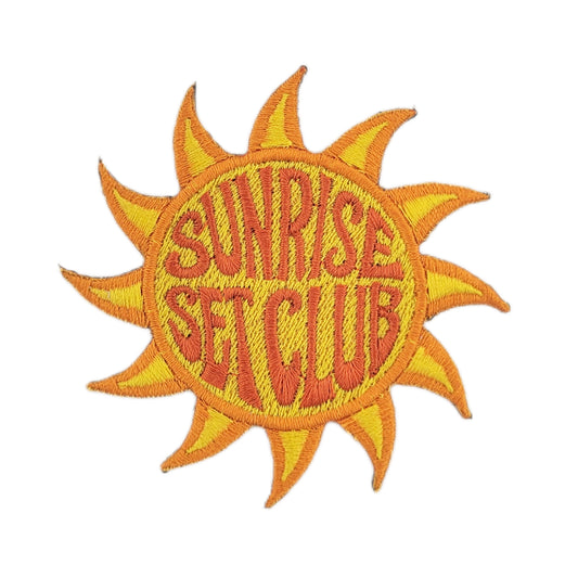 Sun-shaped patch with 'Sunrise Set Club' text on a white background