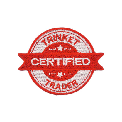 Red and white patch with 'Certified Trinket Trader' text on a white background