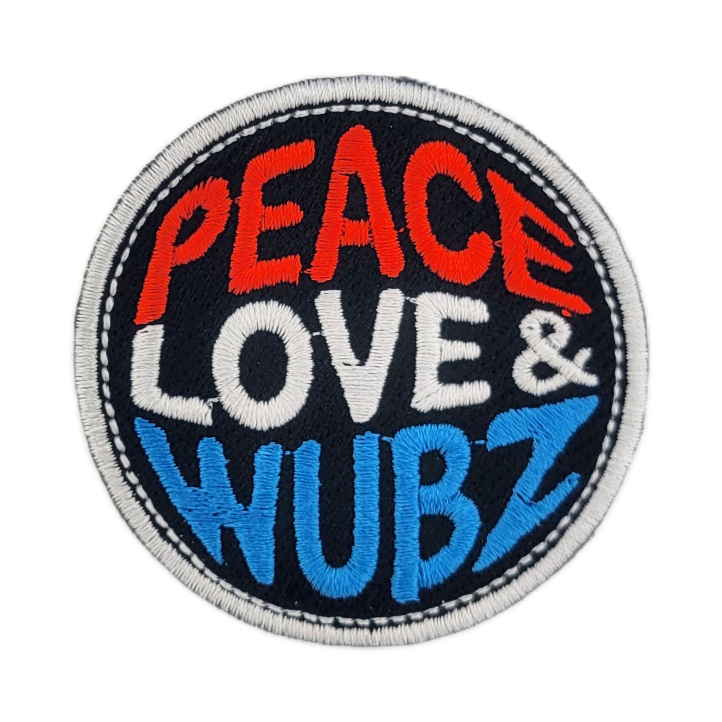 Round patch with 'Peace Love & Wubz' text on a black background