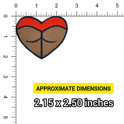 Heart-shaped rave booty embroidered patch, with red bottoms and a dark skin tone. Against a ruler for scale.