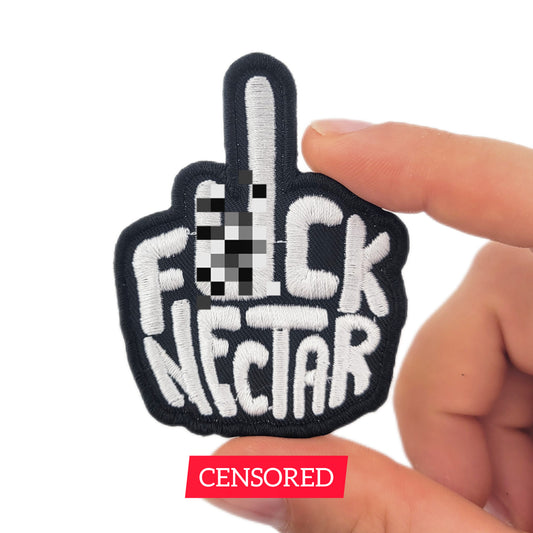 Patch with 'F*ck Nectar' text held by a hand on a white background