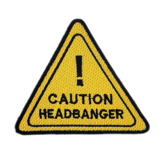 Triangular warning sign patch with 'Caution Headbanger' text on a white background