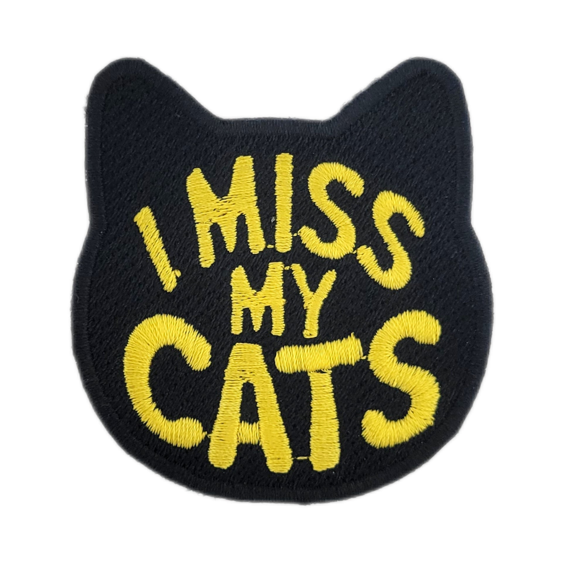 Black patch with yellow text 'I MISS MY CATS' on a white background