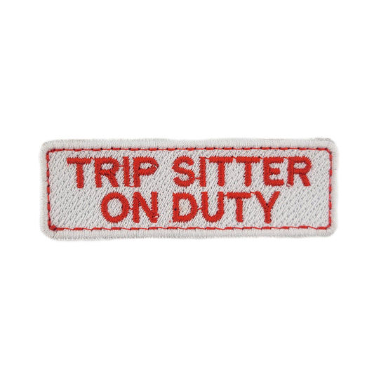Embroidered patch with 'Trip Sitter On Duty' text on a white background